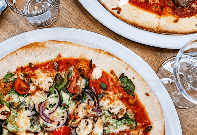 2 pizzas on a table